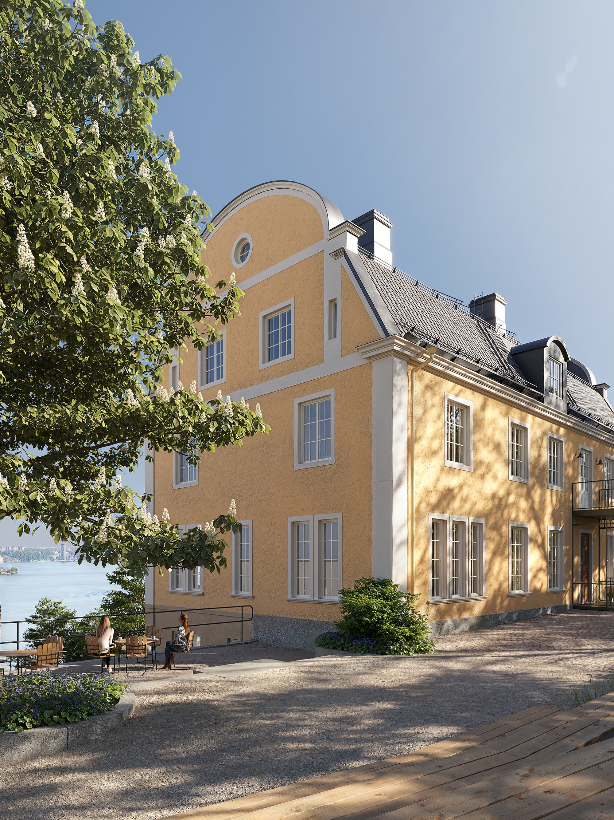 Ett stort gult hus som ligger på toppen av en grönskande sluttning.